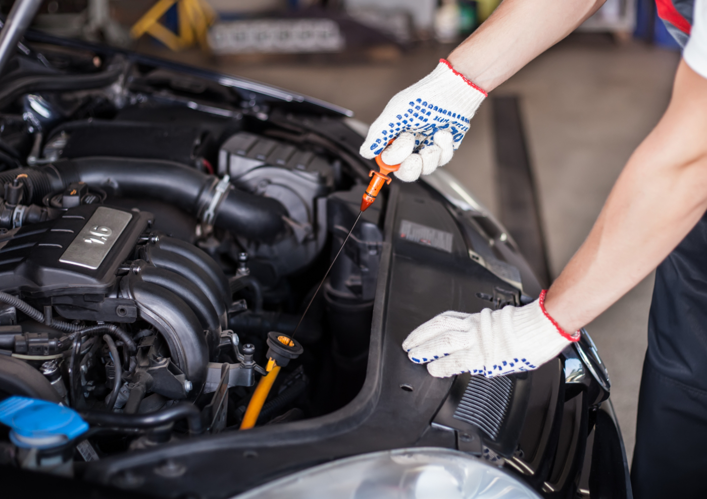 Mechanic changing vehicle oil - Car Servicing Worthing